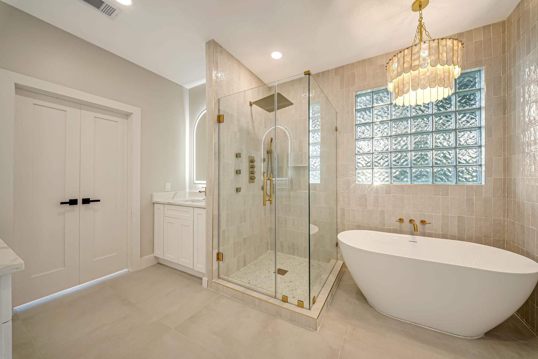 Image 3: Luxurious bathroom featuring a freestanding tub, g
