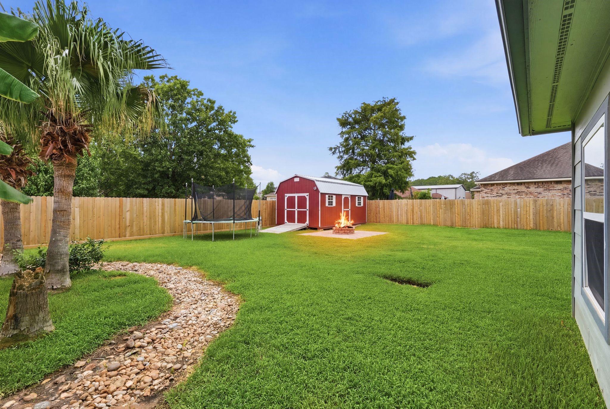 Image 3: The expansive backyard offers plenty of room to pl