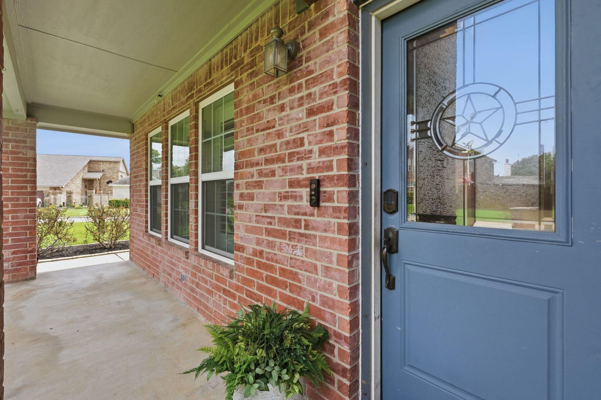 Image 4: A covered back patio creates the perfect place to