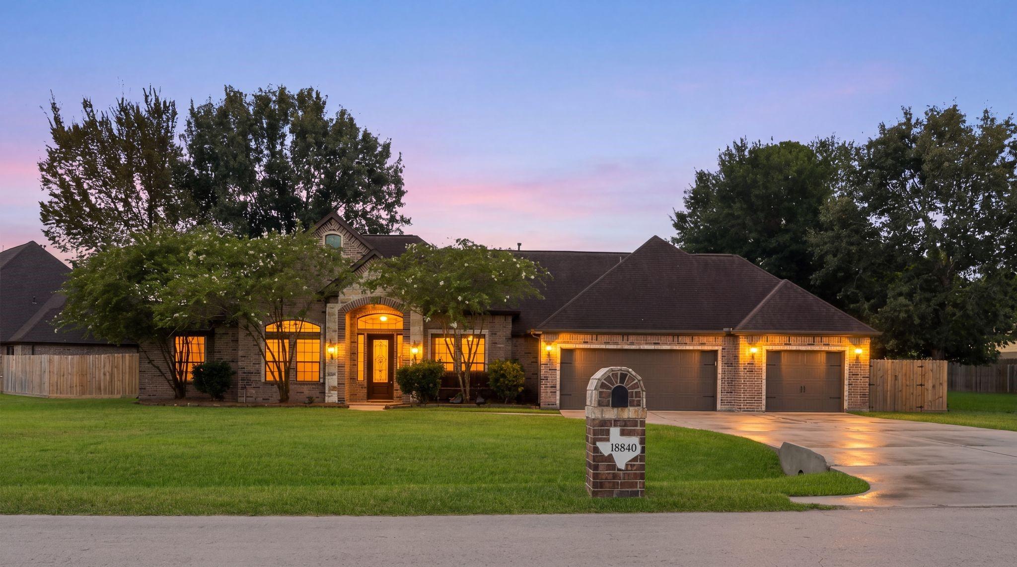 Image 1: Charming brick home with a three-car garage, beaut