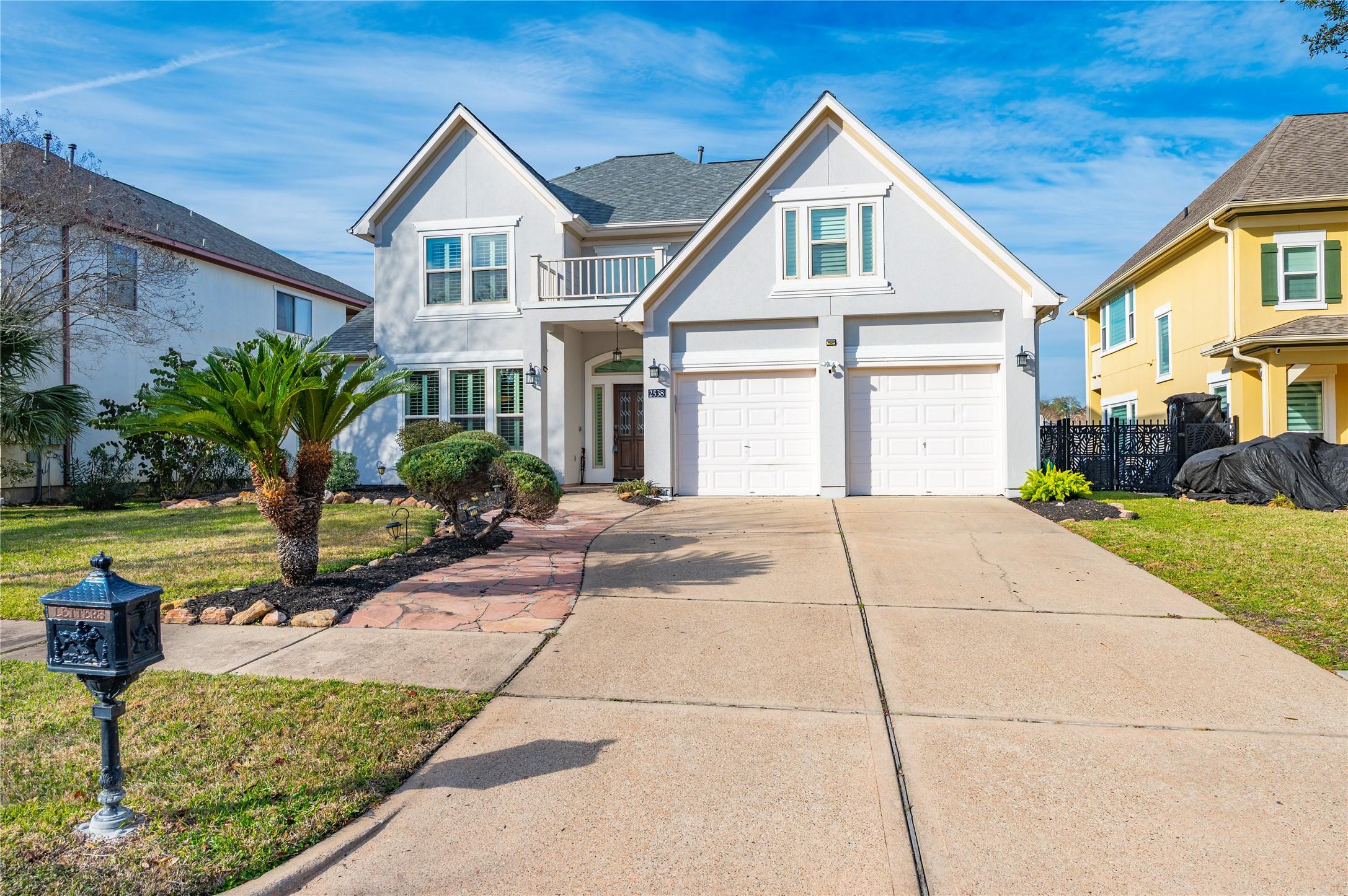 Image 2: This charming two-story home features a modern ext