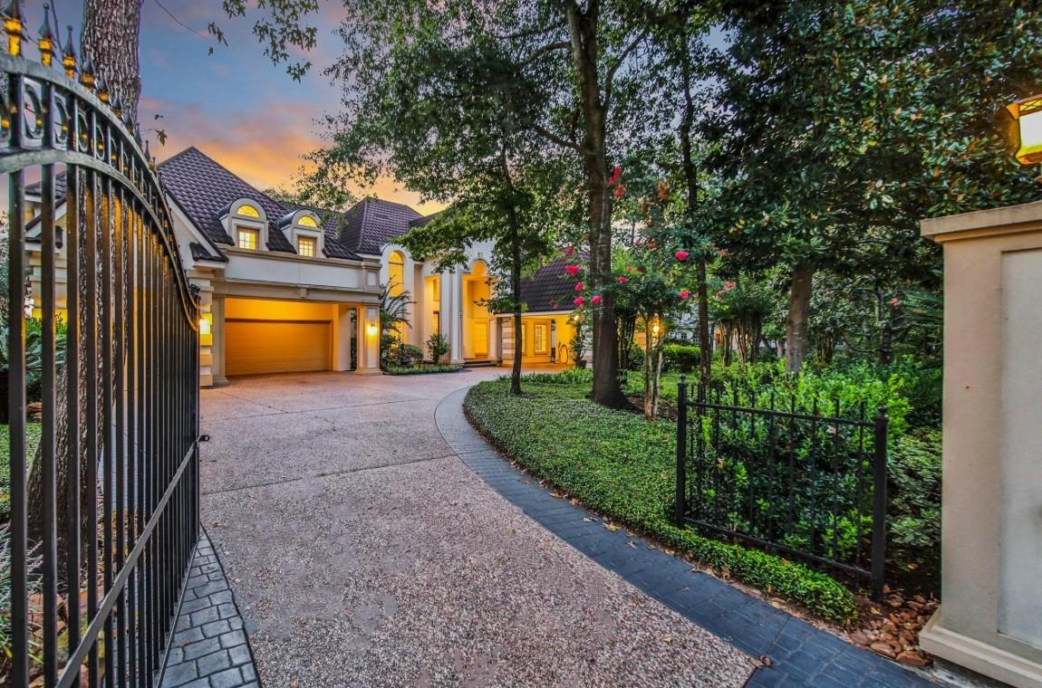 Image 4: Gated driveway leading to the impressive estate wi