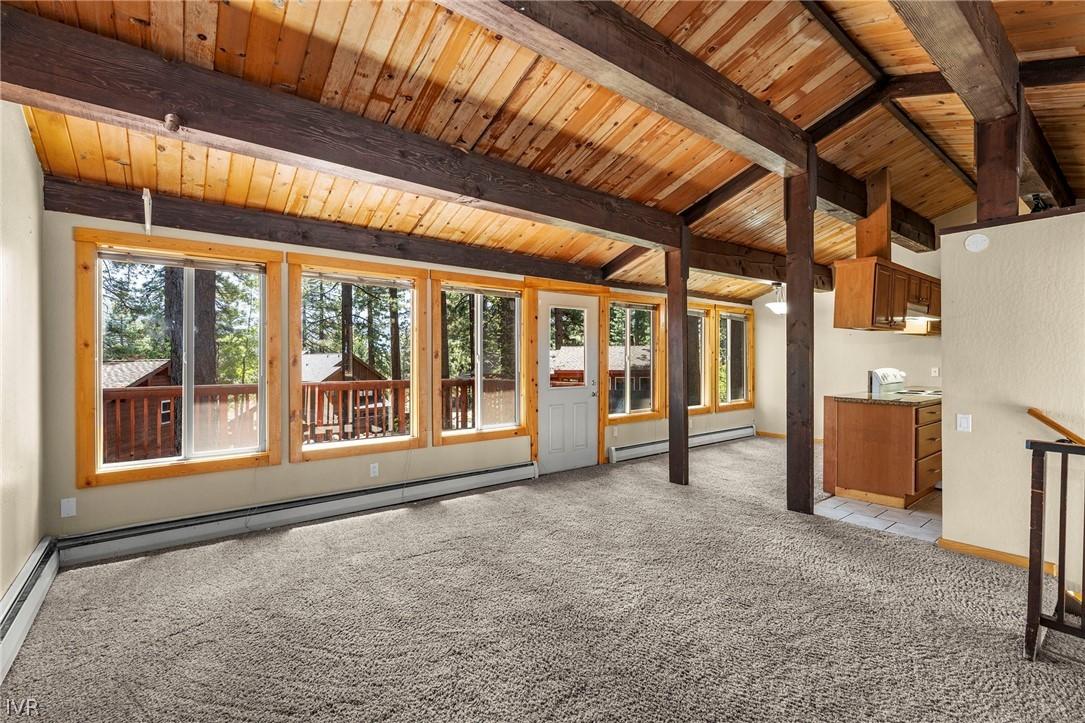 Image 4: Living room with dining room and kitchen view