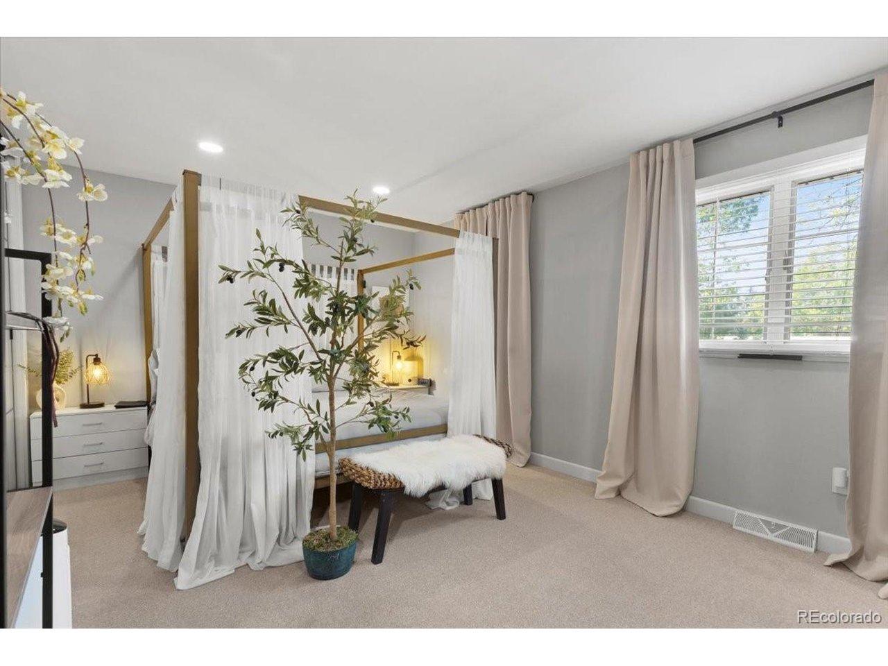Image 4: Spacious Primary Bedroom with en-suite bathroom on upper level.