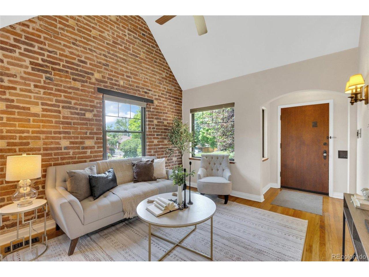 Image 3: vaulted ceiling in living area with exposed brick