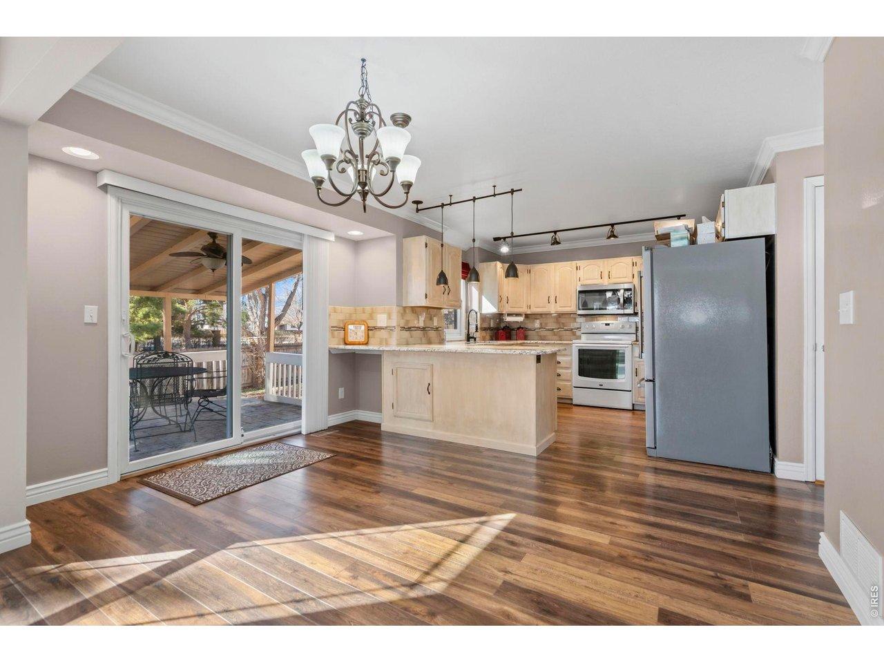 Image 3: Breakfast area into kitchen with granite counters