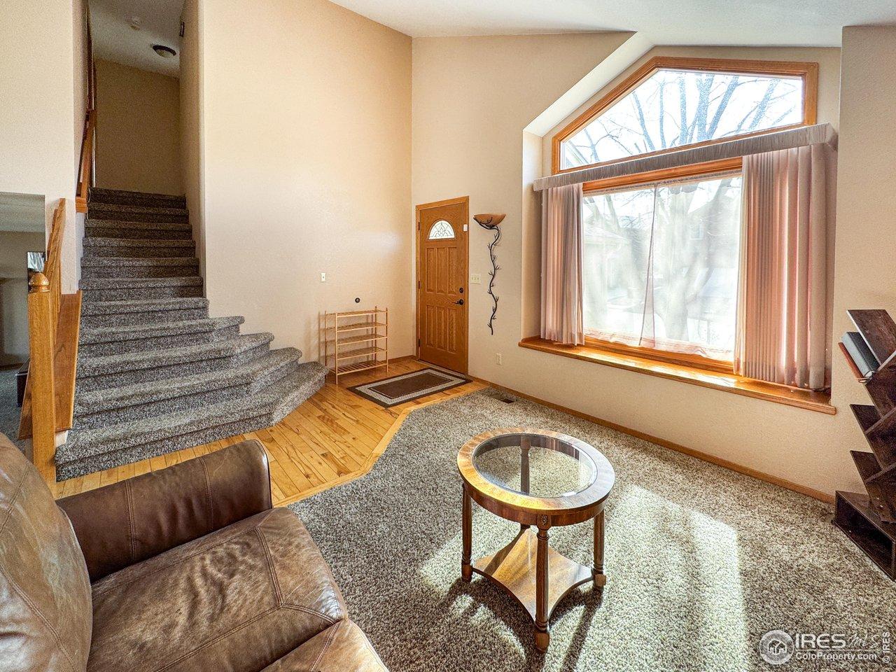 Image 3: Front living area with stairs to upstairs