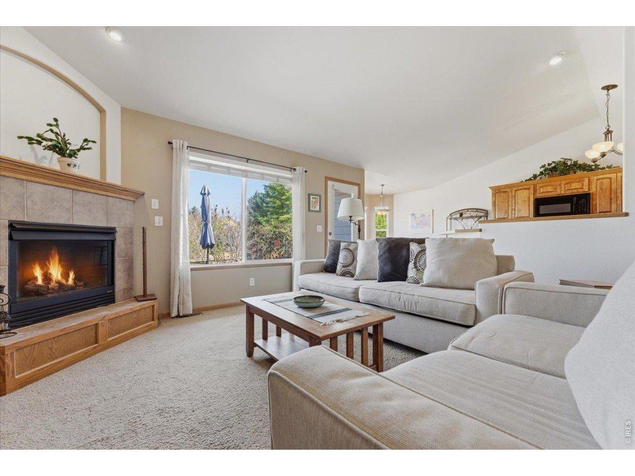 Image 4: Warm and inviting living room featuring vaulted ceilings and a cozy gas fireplace Image 4: Warm and inviting living room featuring vaulted ceilings and a cozy gas fireplace