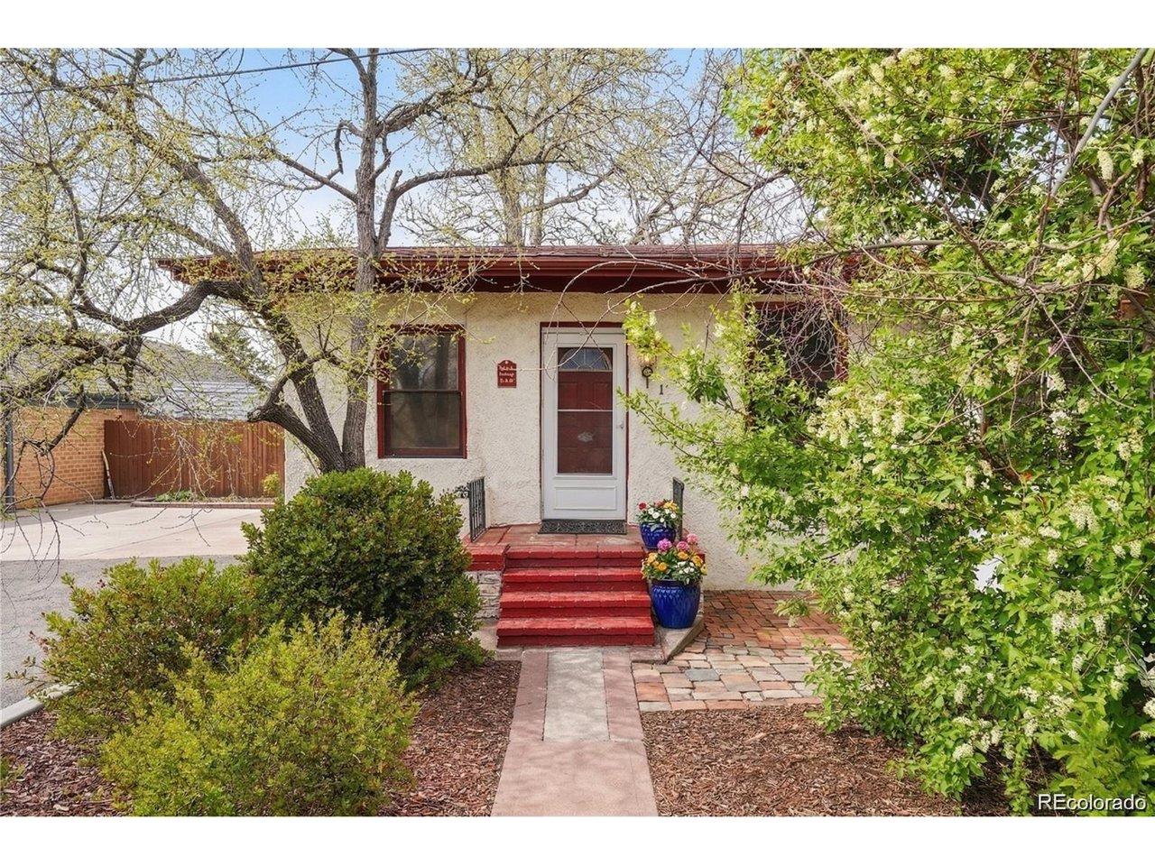 Image 2: Welcoming front entry with mature trees and lush landscaping creating a private setting! A quaint walkway leads to the front door accented by classic details!
