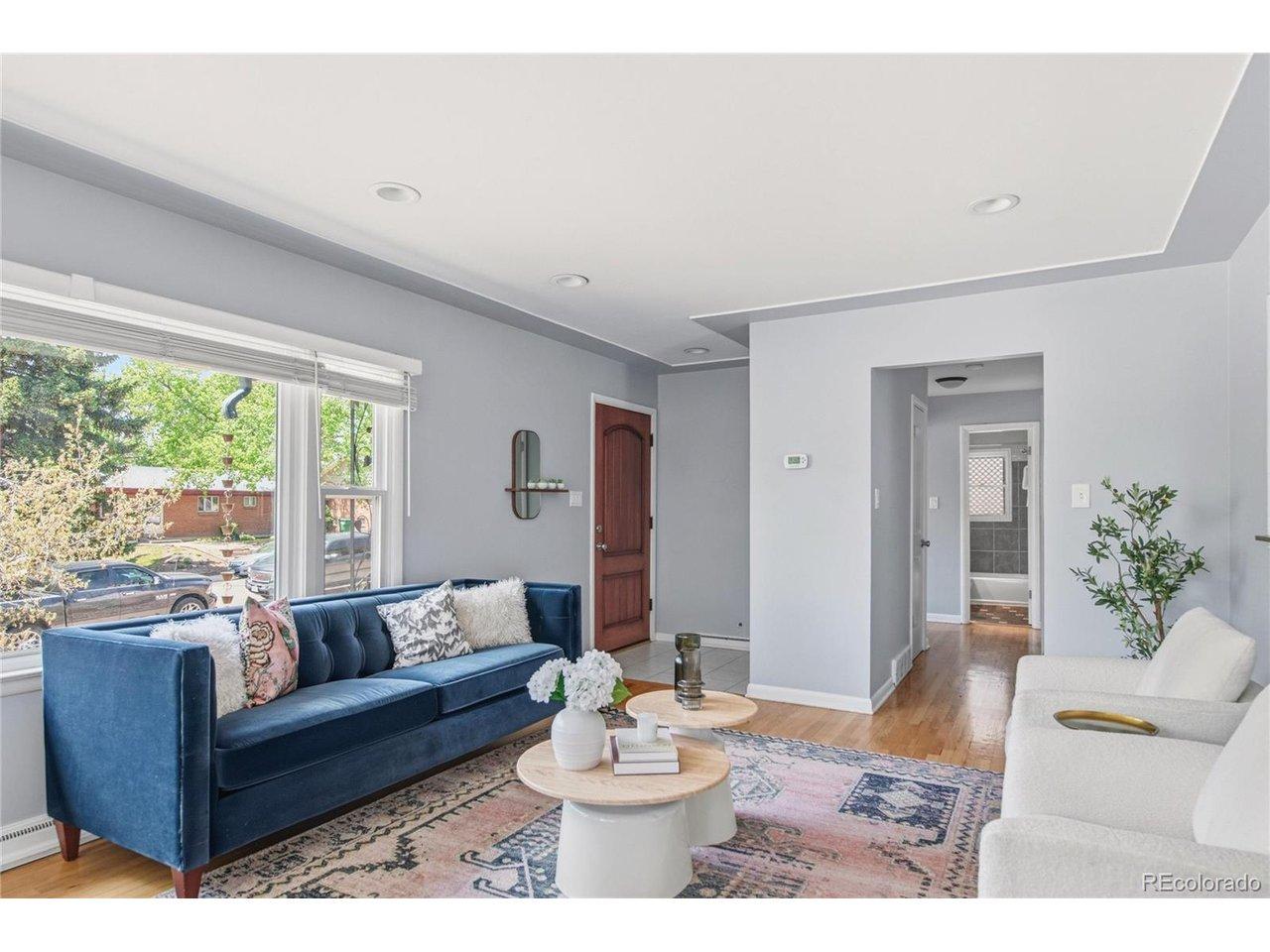 Image 3: The living room opens to the kitchen and dining area