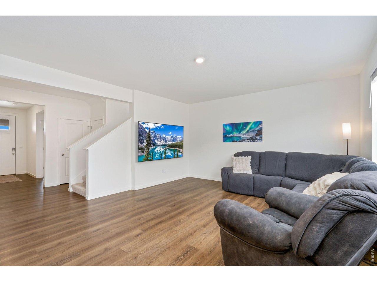 Image 4: Step inside to an open, inviting floor plan where the expansive kitchen flows seamlessly into the dining area and main living space, perfect for entertaining!