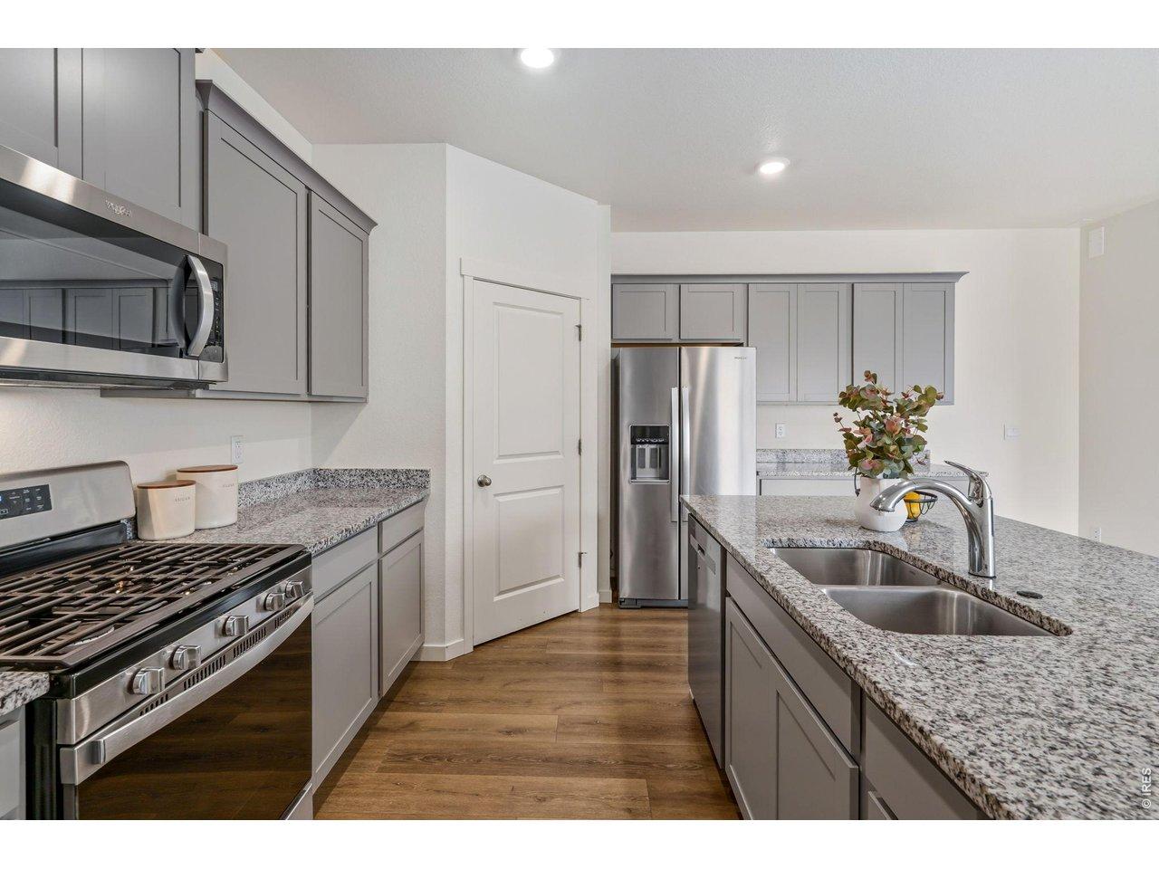 Image 4: High-end kitchen appliances including a gas range. Image 4: High-end kitchen appliances including a gas range.