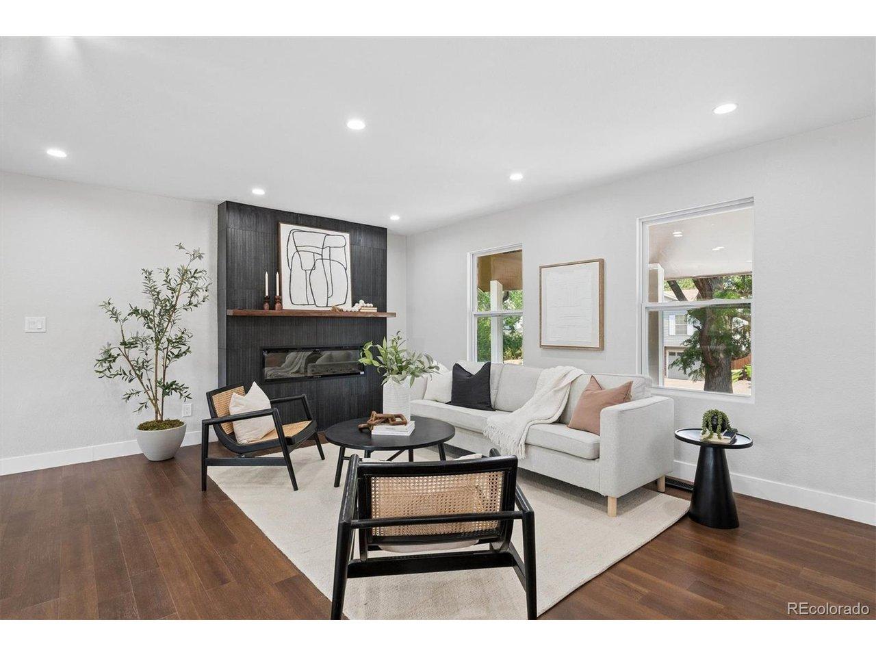 Image 3: Open concept with new fireplace put in highlighted by black oak mantle