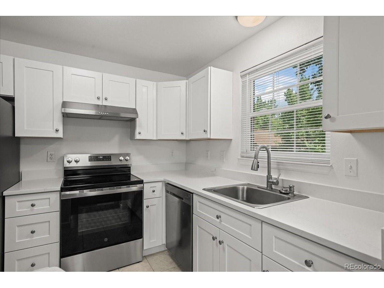 Image 2: Beautiful kitchen with new cabinets, new stainless steel appliances, and quartz countertops