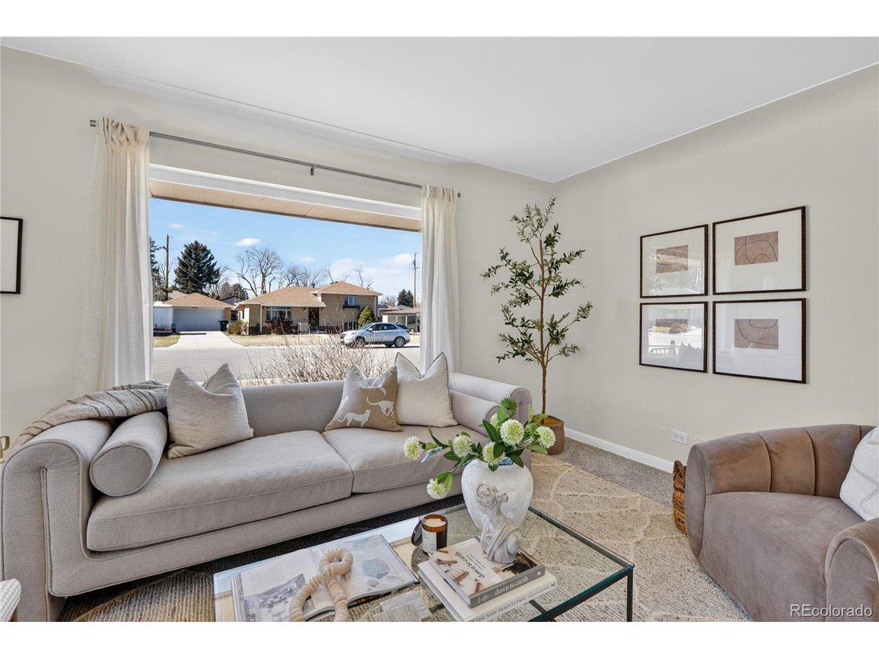 Image 4: Living room featuring a large window and abundant natural light.
