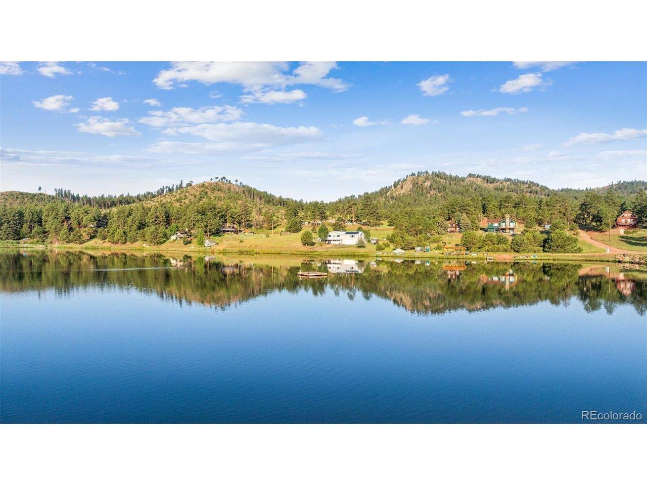 Image 2: Water view with a forest and a mountain backdrop.