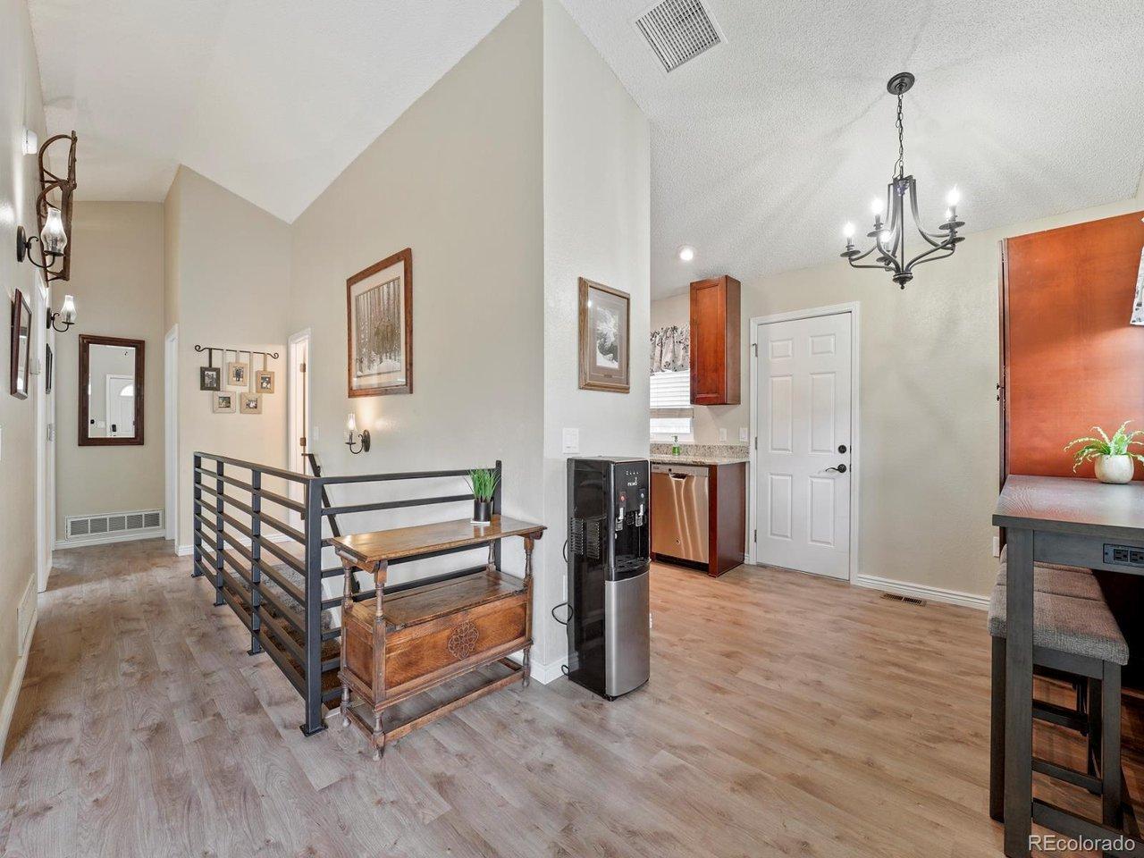 Image 3: Custom railing, vaulted ceiling, room for larger table or center island if desired