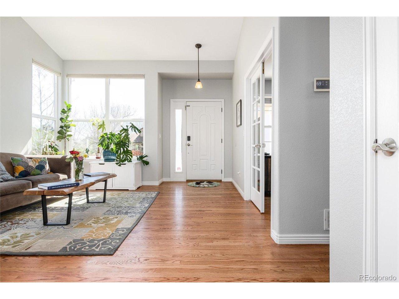 Image 4: Inside you are greeted by a living room with vaulted ceilings and lots of natural light