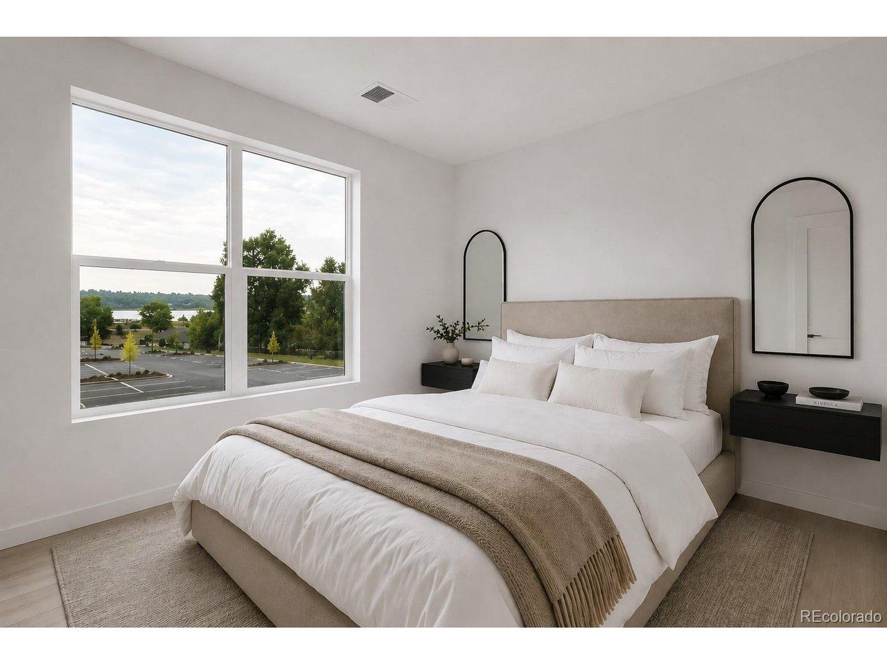 Image 4: Primary bedroom offers a view of Sloan's lake.*Photos are of a similar unit and features may not be exact. Image 4: Primary bedroom offers a view of Sloan's lake.*Photos are of a similar unit and features may not be exact.