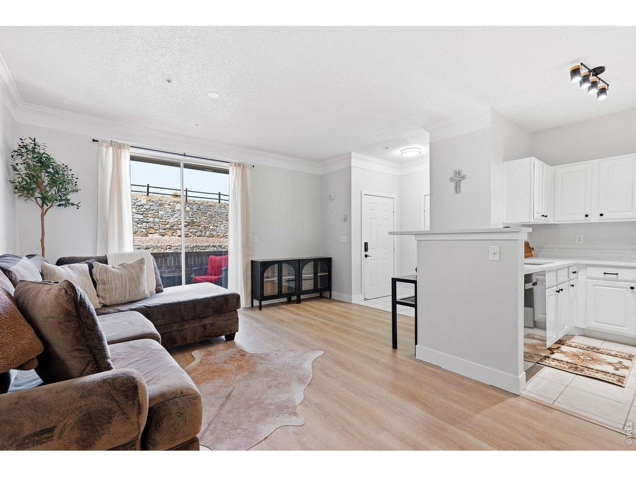 Image 3: LVP flooring, fresh paint, new baseboards and door casings are waiting inside this open floor plan that is filled with light from the sliding glass door.