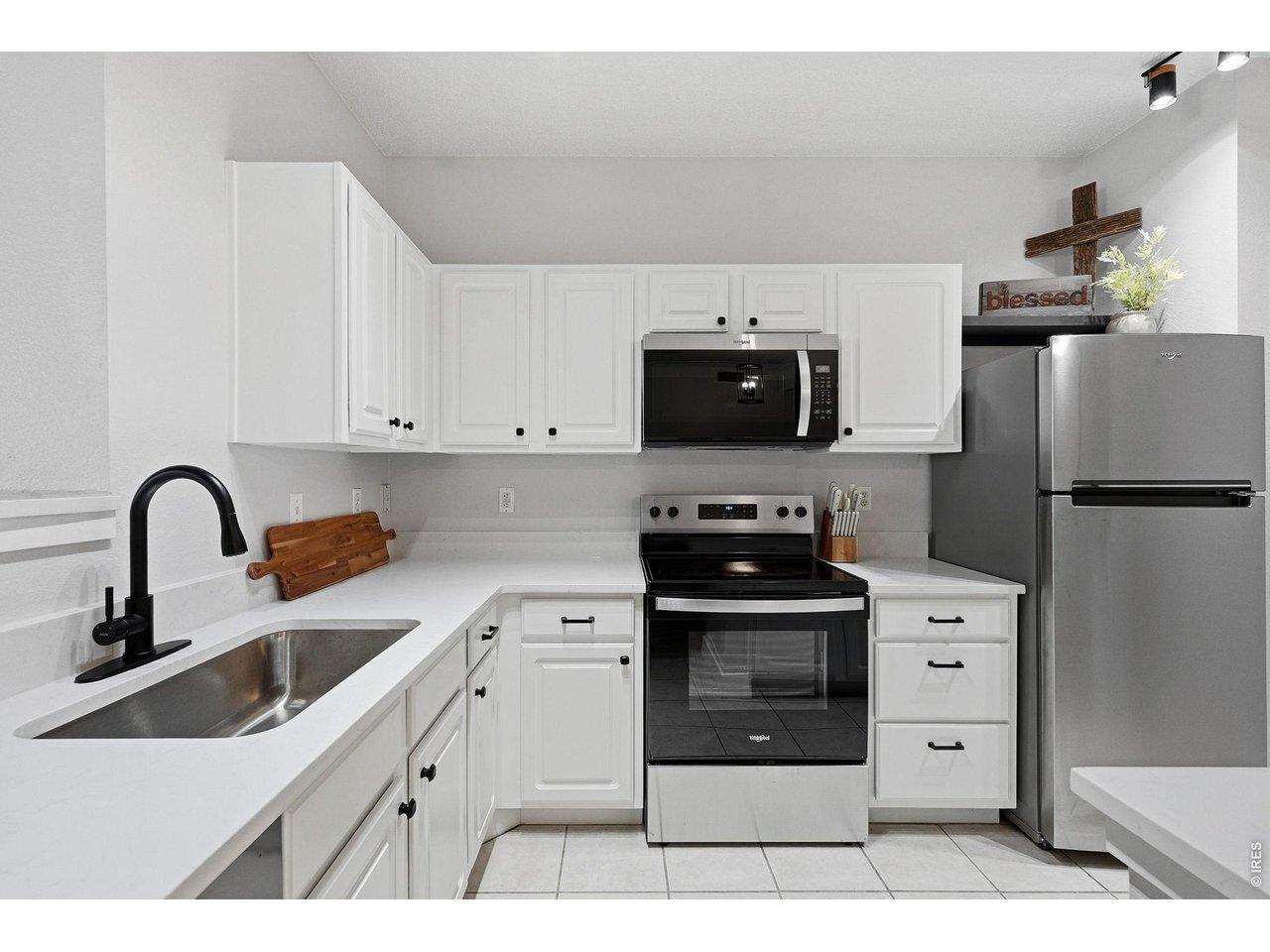 Image 4: New appliances and quartz counters were added in 2025 for a sizable and modern kitchen with a large pantry.