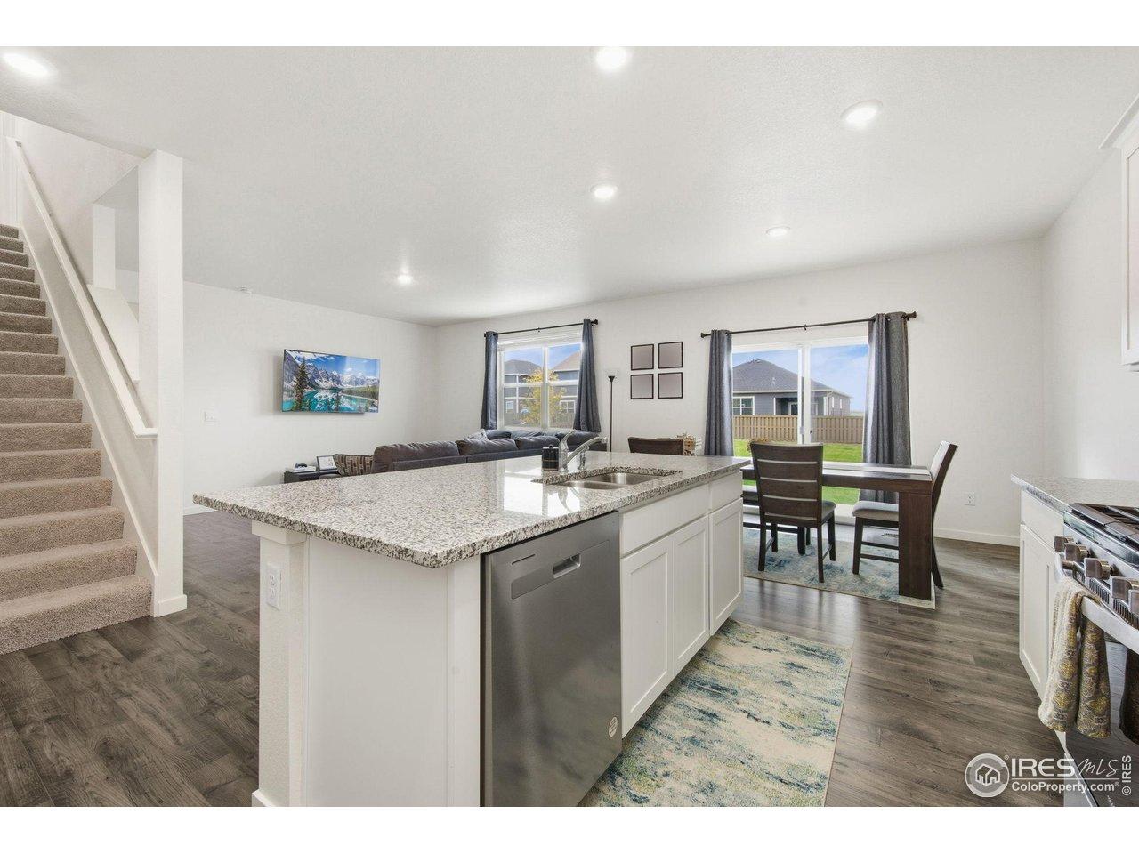 Image 3: Kitchen to Dining and Living Areas