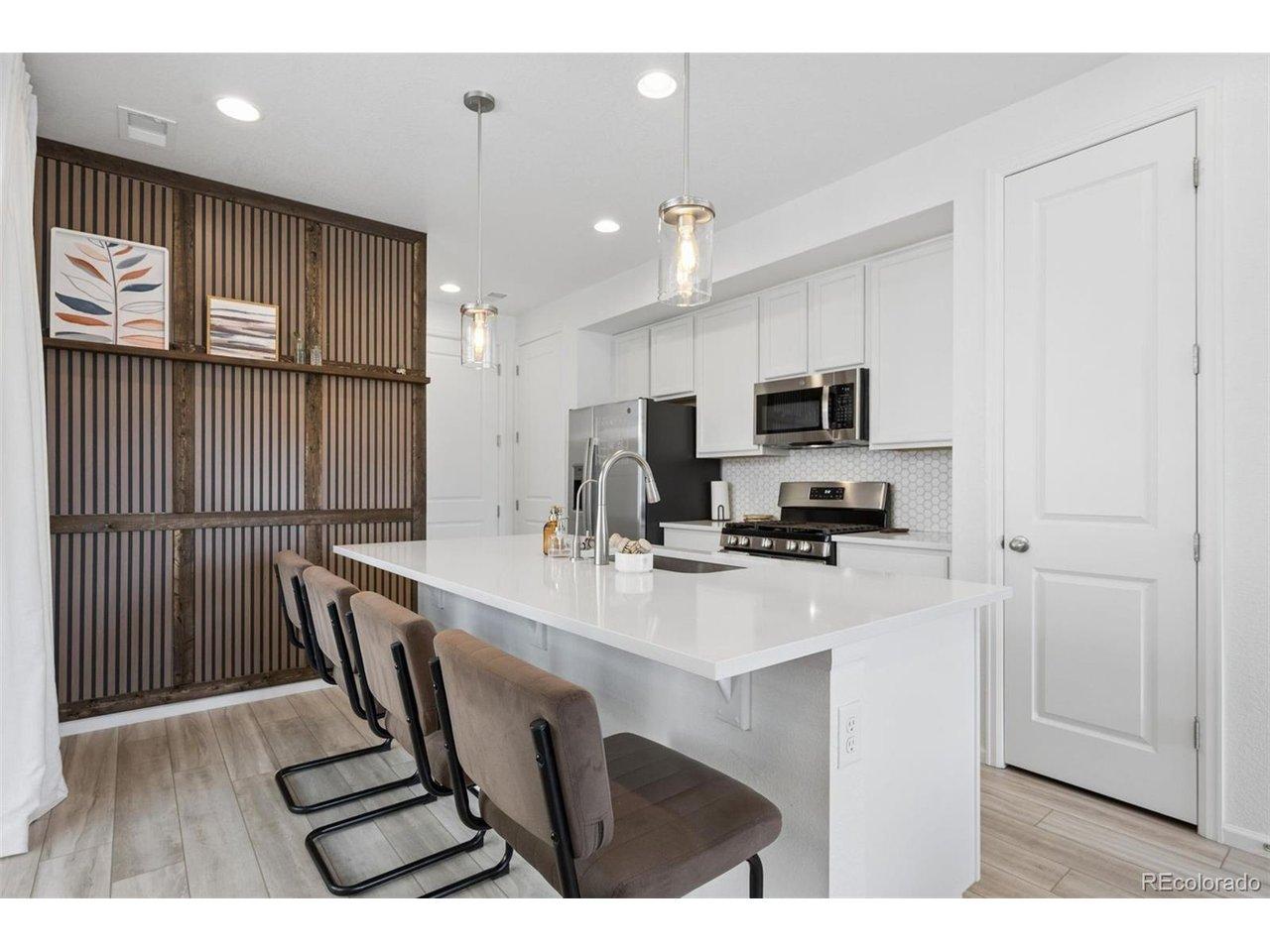Image 2: Eat in kitchen with accent wall, gorgeous quartz countertops, a large pantry, spice pantry, and gas stove Image 2: Eat in kitchen with accent wall, gorgeous quartz countertops, a large pantry, spice pantry, and gas stove
