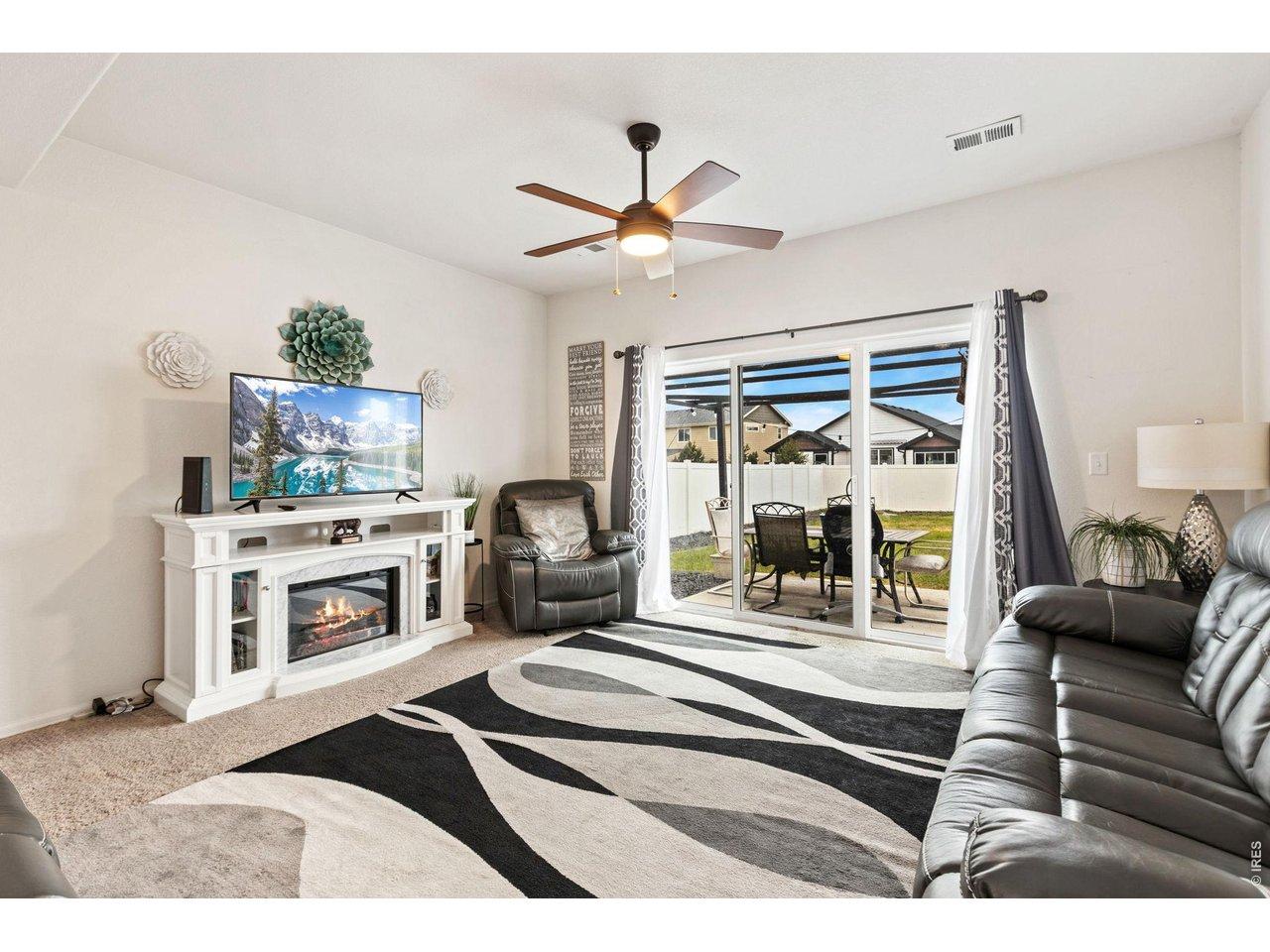 Image 4: Living Room filled with natural light and provides warm comfortable space for everyday living.