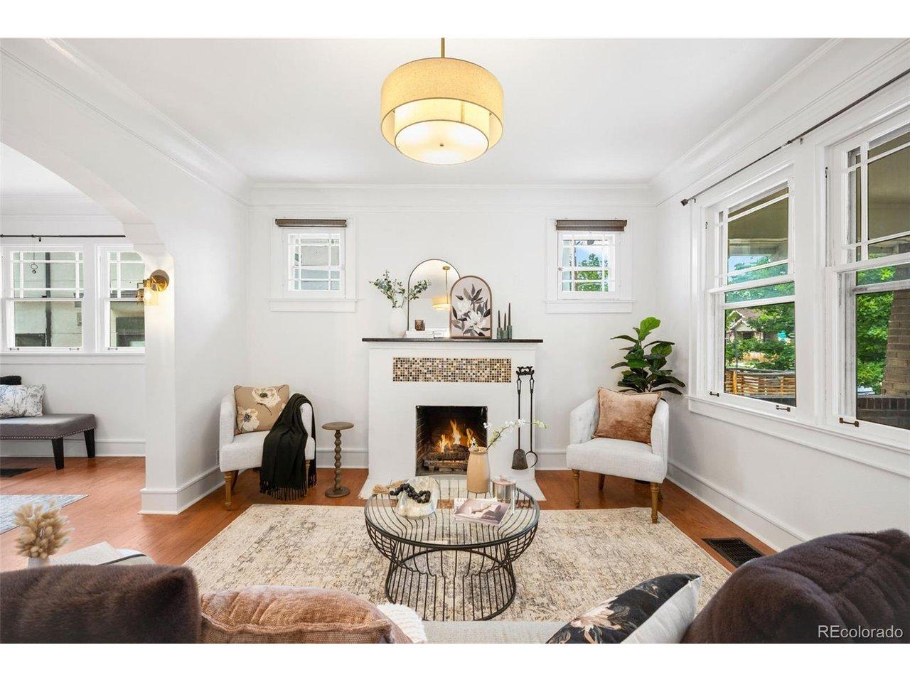 Image 4: Greeted by spacious main level with hardwoods and charming mantel. Image 4: Greeted by spacious main level with hardwoods and charming mantel.