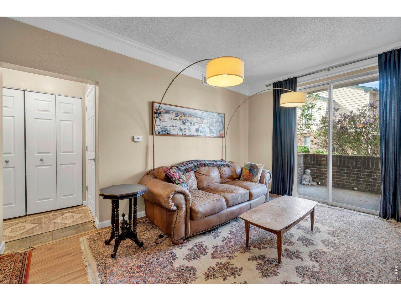 Image 4: Living room and hallway with laundry closet