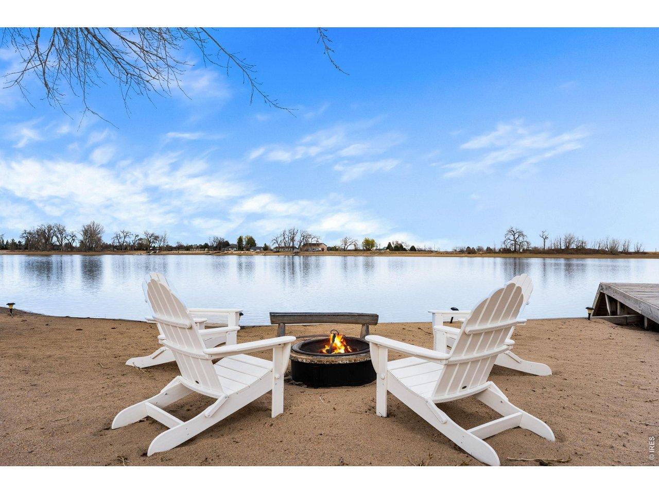 Image 3: Vacation at home! Relax on your private sandy beach around the fire pit as the sun goes down