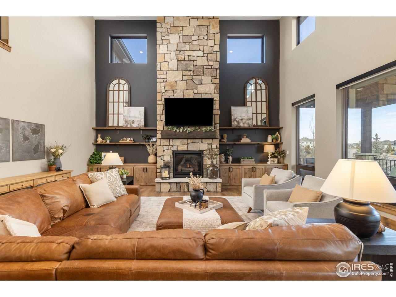 Image 2: Stacked Fireplace with Hearth and Mantle, Built-in Cabinets, and Custom Floating Shelves