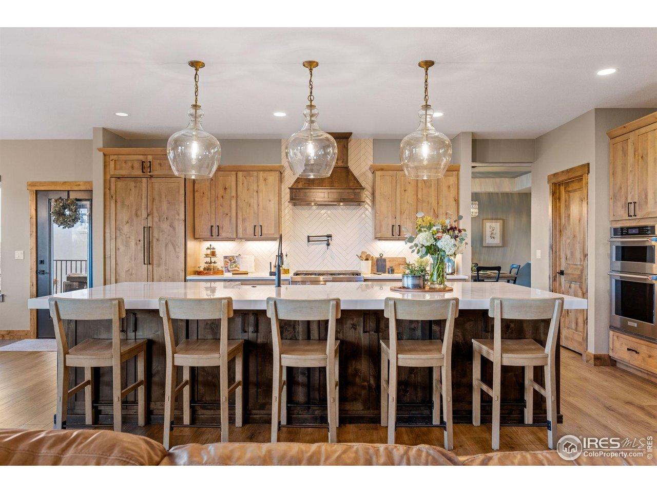 Image 3: Spacious Chef's Kitchen with oversized Center Quartz Island with Farm Sink, Knotty Elder Cabinetry