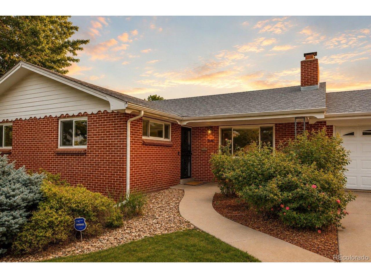 Image 2: Entry with rose bushes and a covered front porch