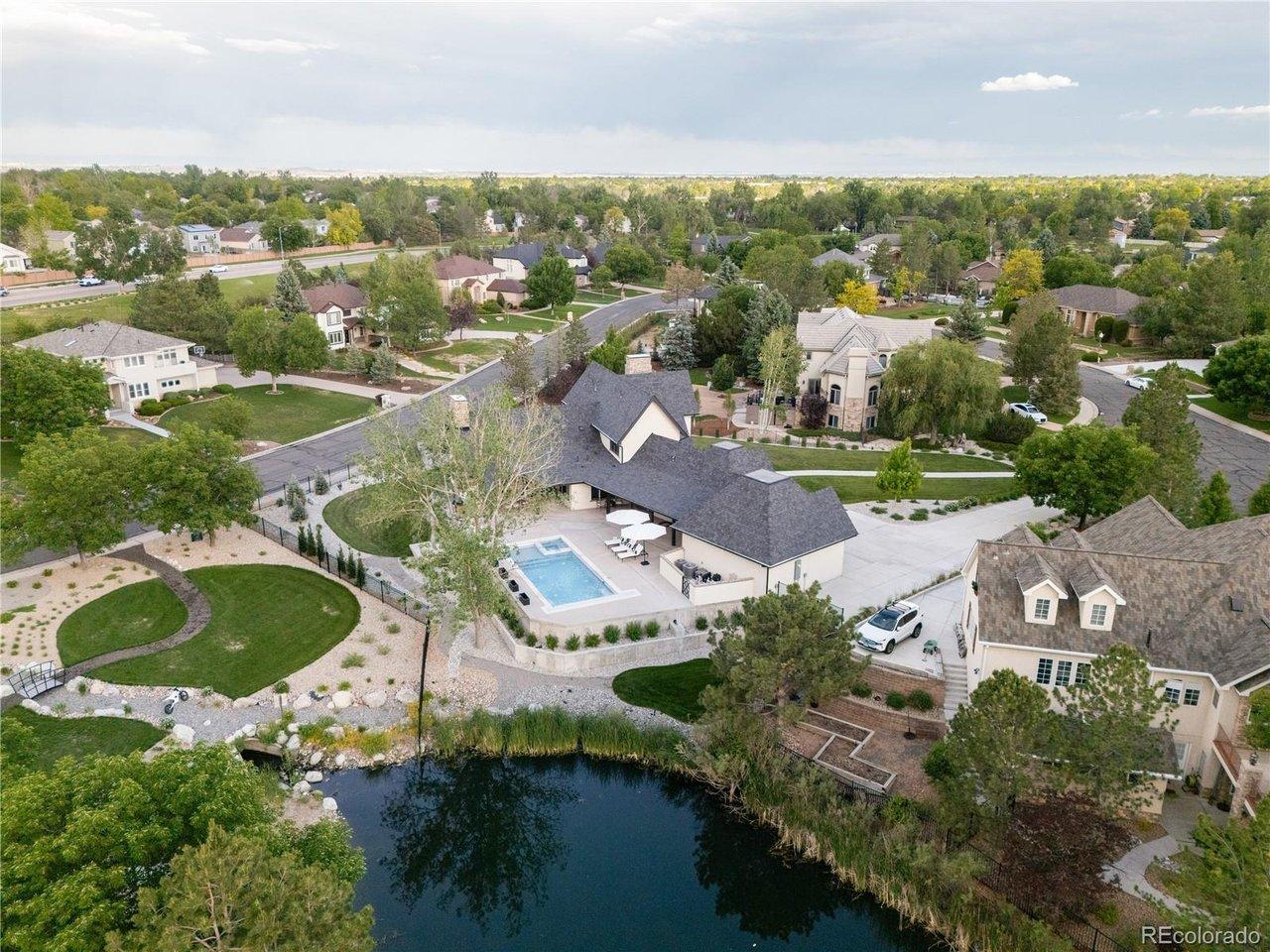 Image 1: Private lakefront setting with pool, patio, and beautifully landscaped grounds.