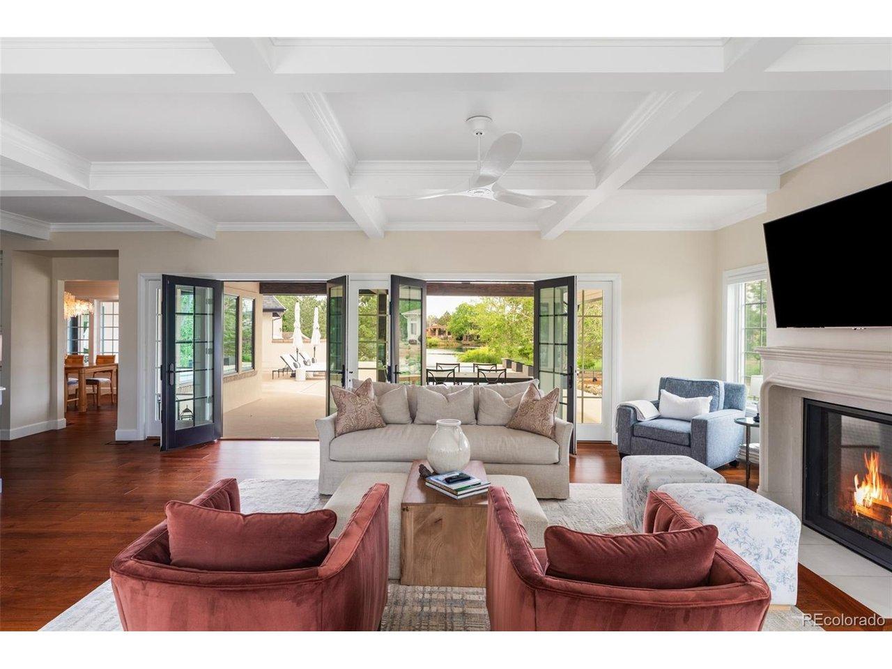 Image 4: Great room opens to the covered patio with lake views beyond.