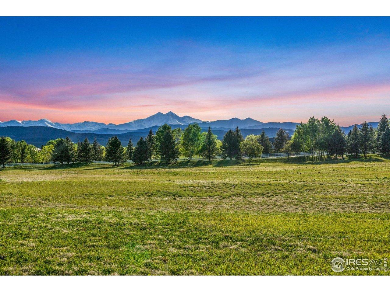 Image 1: Unobstructed evening view of mountain range from lot.