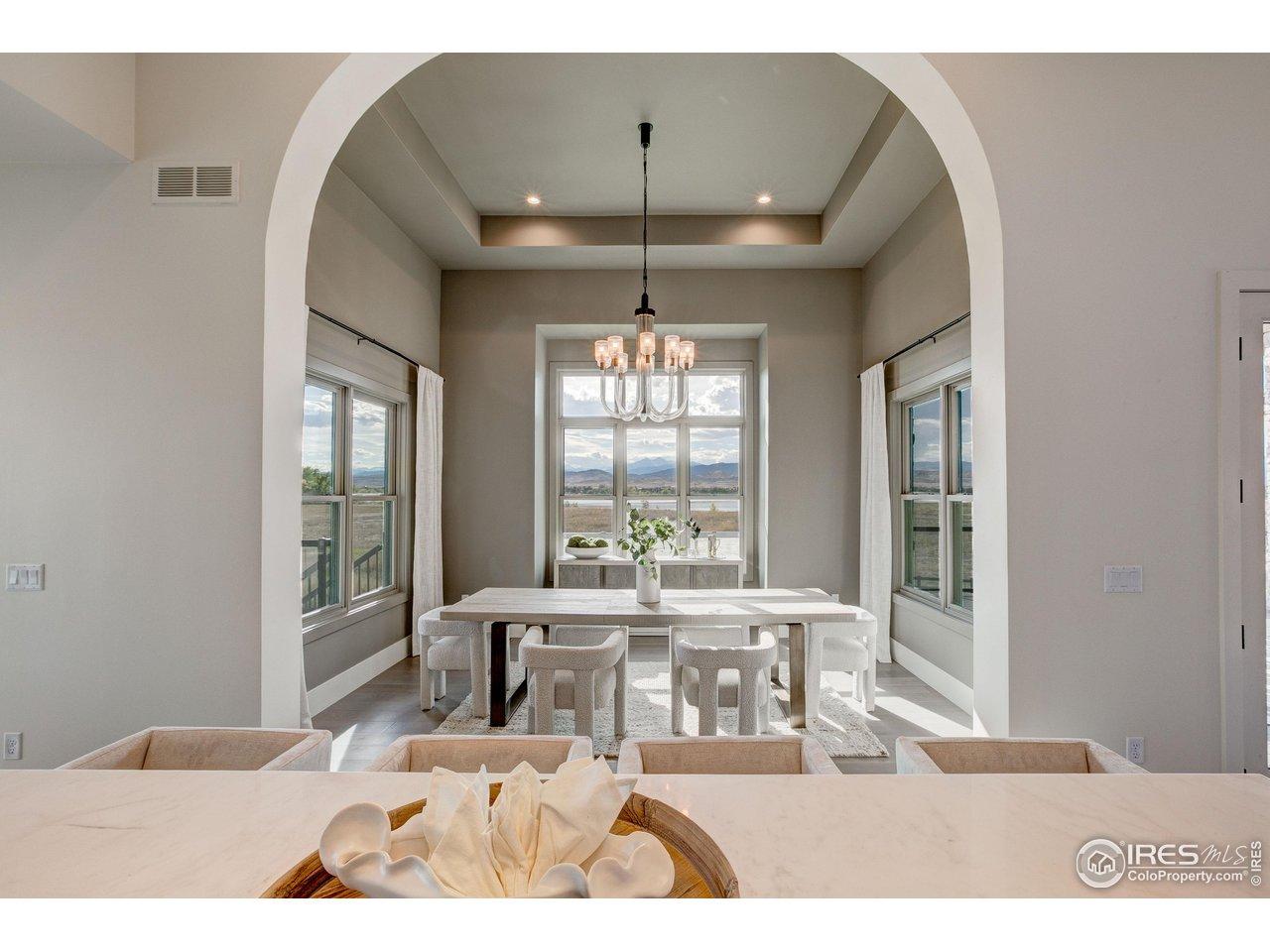 Image 4: Separate dining room from the kitchen creates a dedicated space to entertain and take in the incredible views of Lone Tree Reservoir & the mountains. Image 4: Separate dining room from the kitchen creates a dedicated space to entertain and take in the incredible views of Lone Tree Reservoir & the mountains.