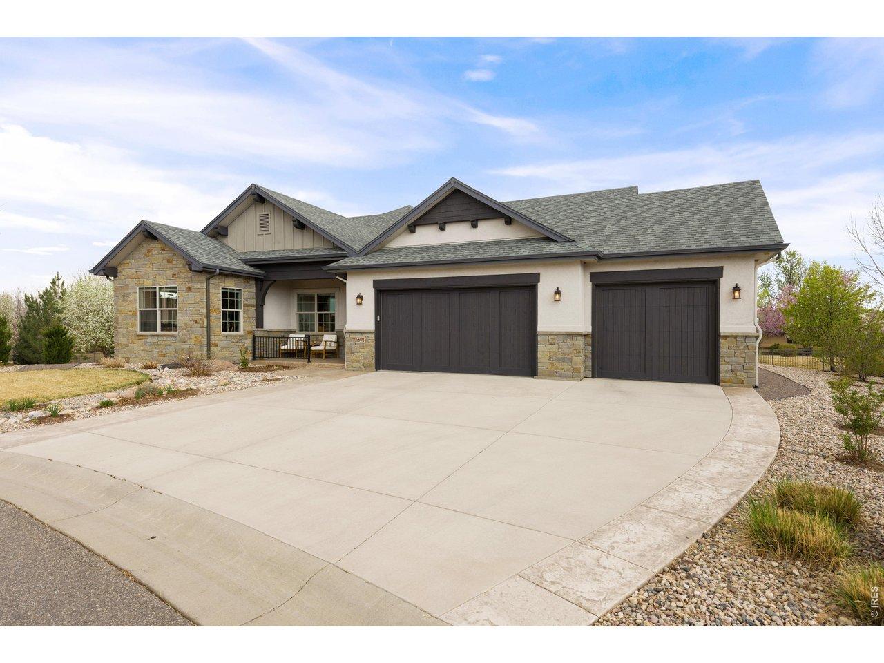 Image 2: Front Exterior: Inviting curb appeal with spacious driveway