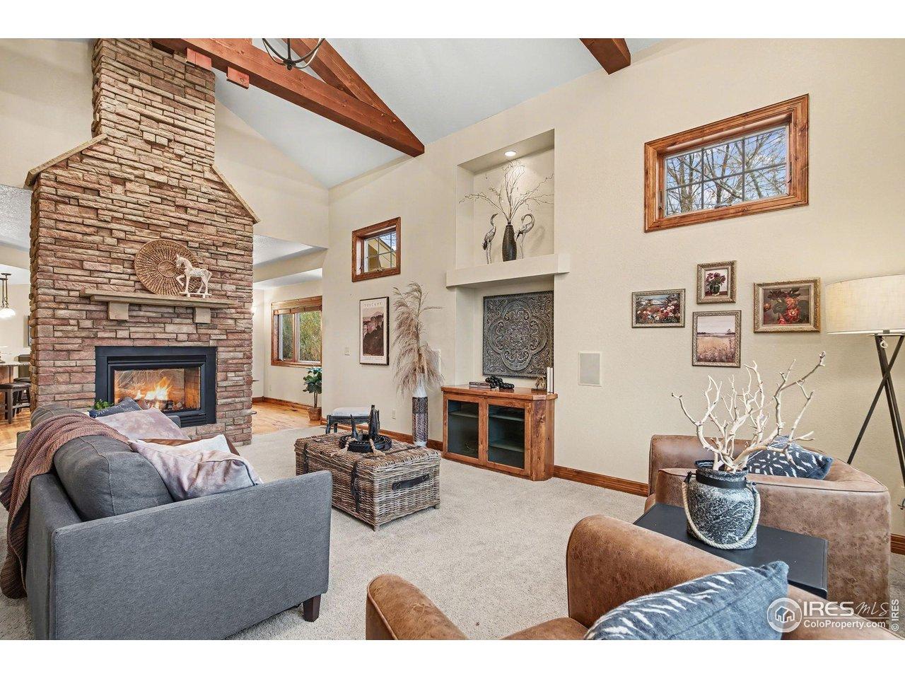Image 4: Gorgeous Open Floorplan.  Living Room boasts double-sided gas fireplace, built-in cabinetry, oversized windows and vaulted, beamed ceiling.