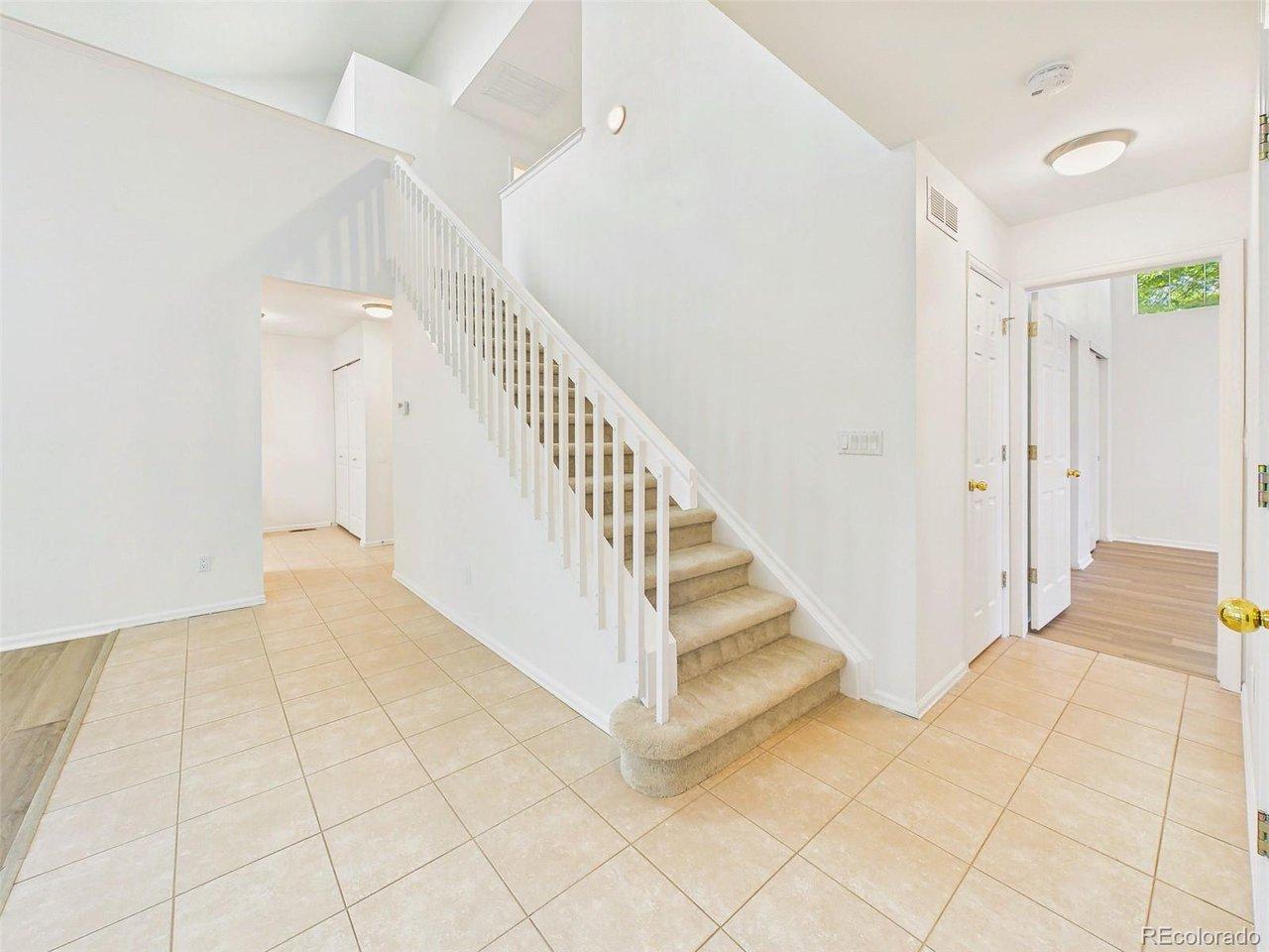 Image 3: Foyer & Staircase - Welcoming entry with tile flooring, a central staircase, and easy access to main-level living spaces. Image 3: Foyer & Staircase - Welcoming entry with tile flooring, a central staircase, and easy access to main-level living spaces.