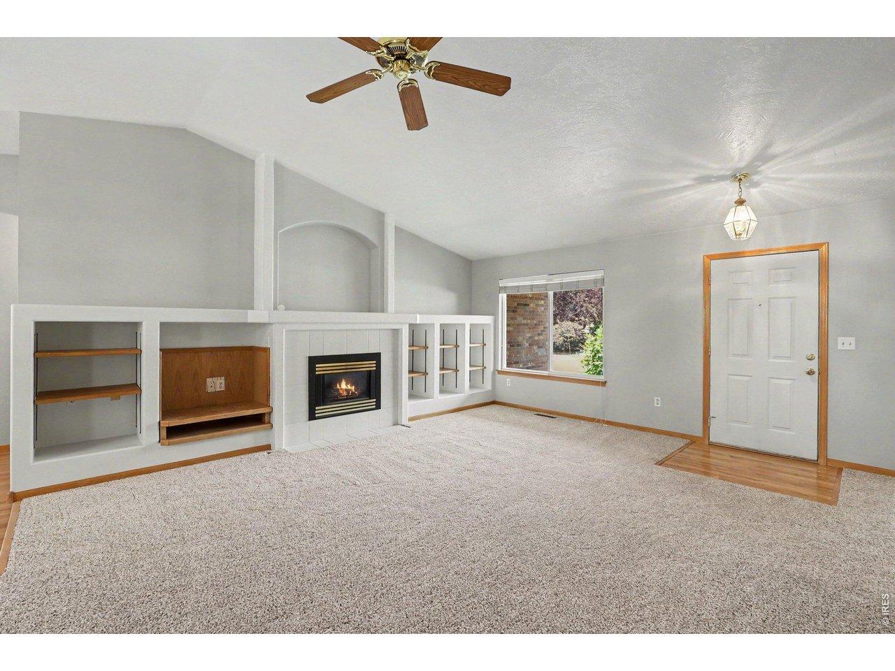 Image 2: Features new carpeting and cozy gas fireplace with built-in shelving