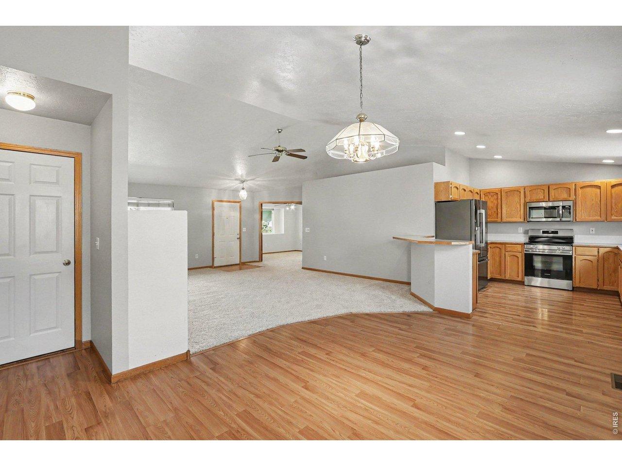Image 4: Open-concept living room flows seamlessly into the dining area and kitchen