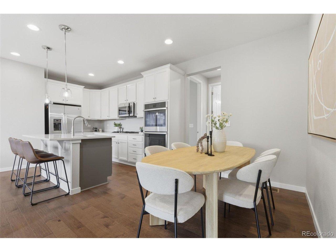 Image 2: Open kitchen and dining space with large center island Image 2: Open kitchen and dining space with large center island