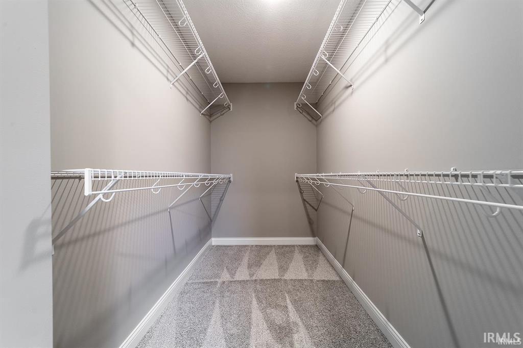 Image 1: Walk in closet with light colored carpet, Walk In Closets Image 1: Walk in closet with light colored carpet, Walk In Closets
