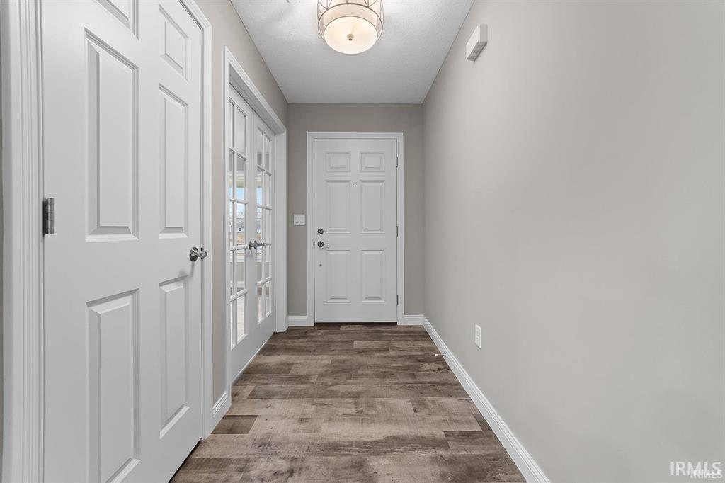 Image 2: Doorway to outside with wood finished floors and french doors, Entry Image 2: Doorway to outside with wood finished floors and french doors, Entry