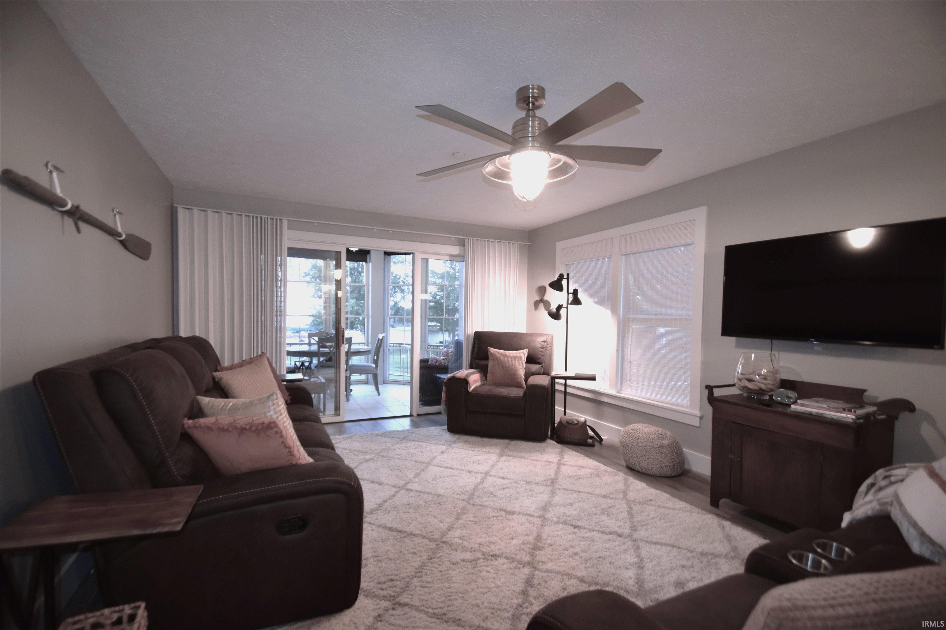 Image 2: Living area with a ceiling fan and light wood-type flooring, Living Room