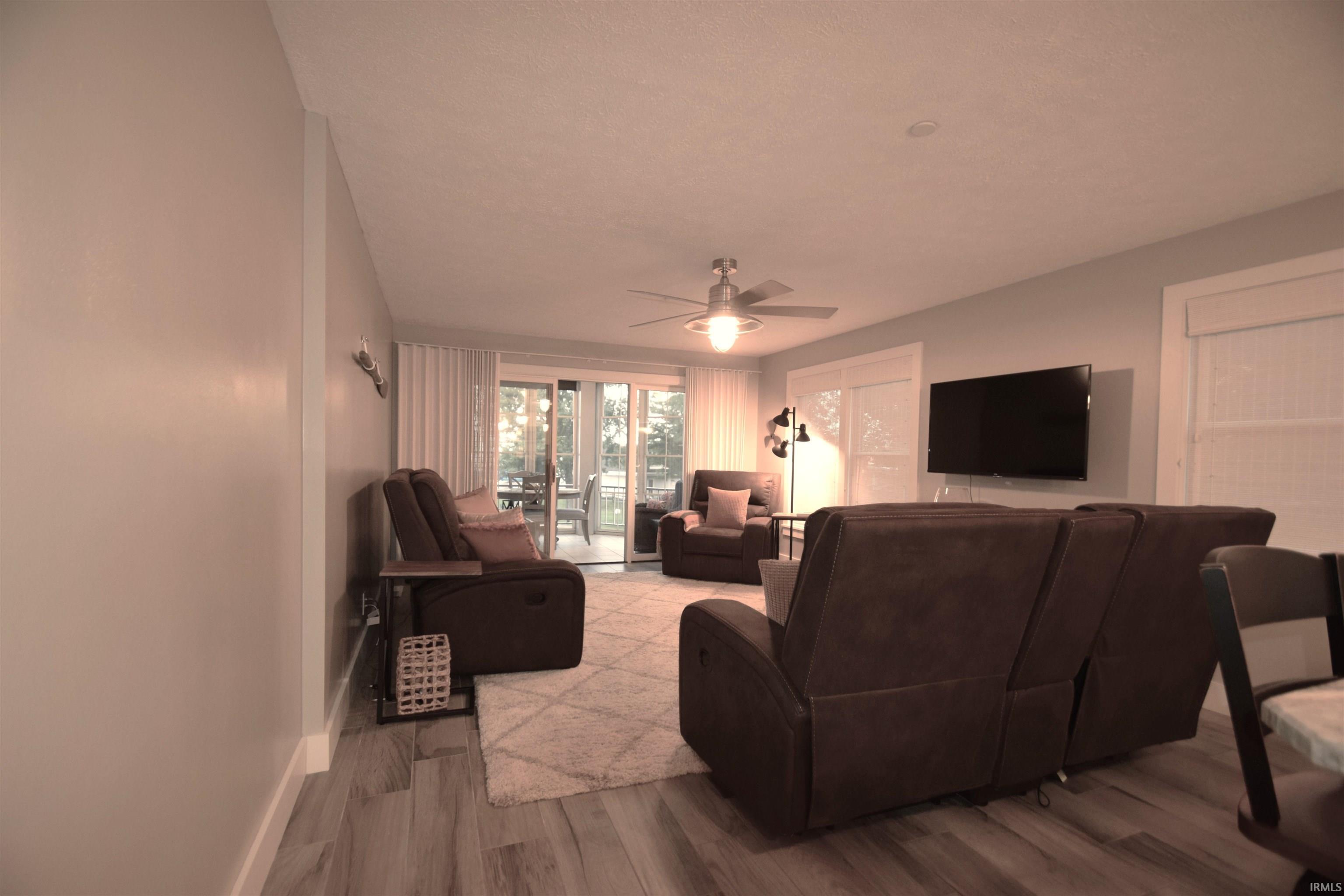 Image 3: Living area with wood finished floors and a ceiling fan, Living Room
