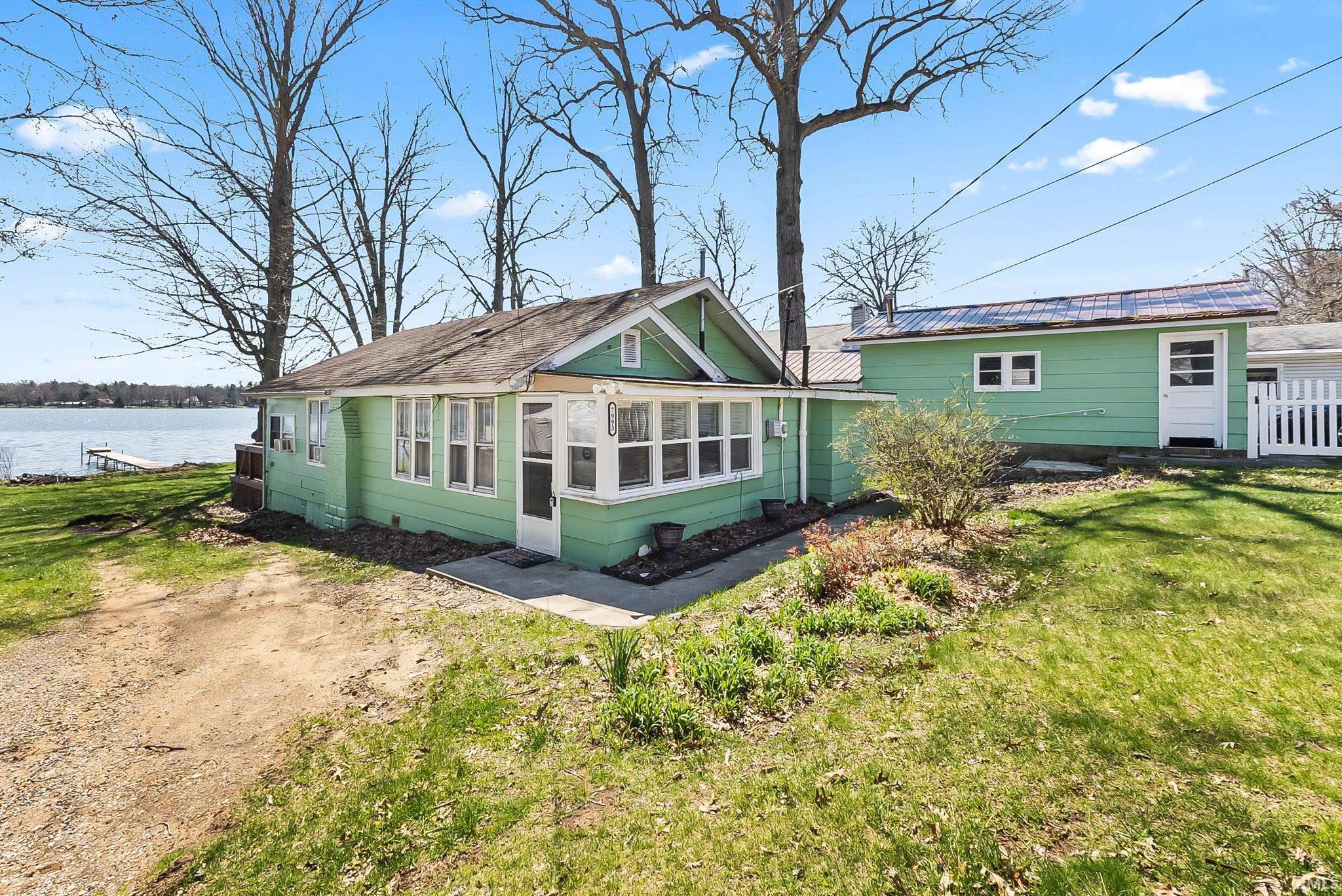 Image 0: View of front facade with a sunroom and a front lawn, Front Of Structure