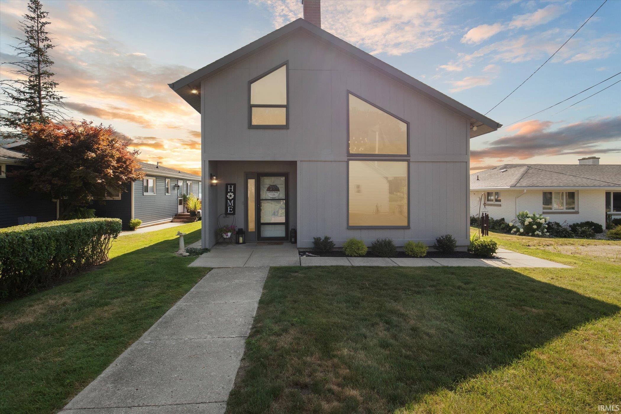 Image 0: Modern home with a front lawn and a chimney, Front Of Structure